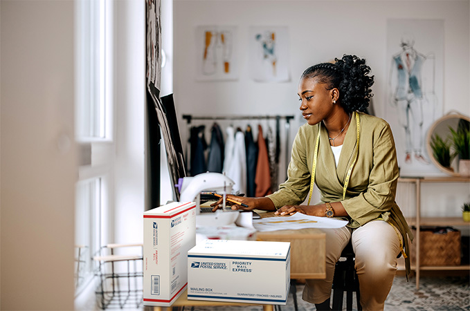 Small business owner with a stack of packages ready for shipment.